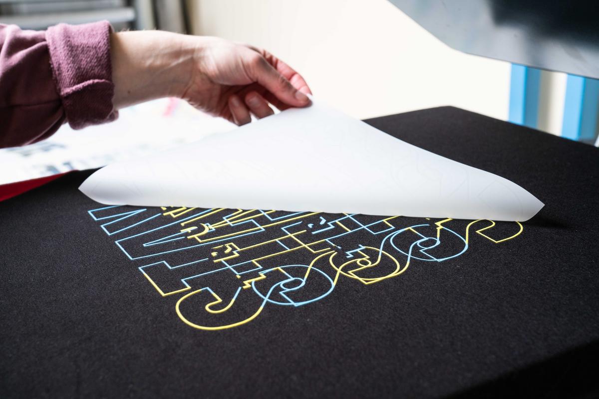 Direct to film print being pressed onto a black t-shirt