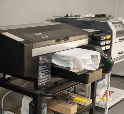 Direct to garment machine with white t-shirt being printed